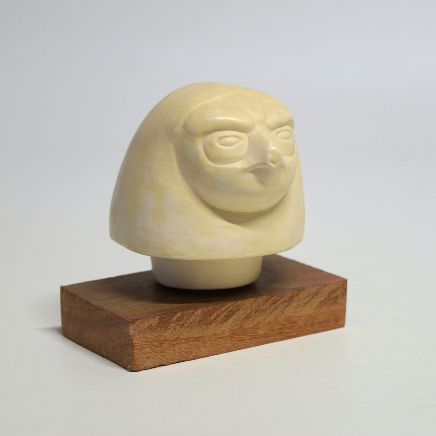 Quebehsenouf "falcon head" canopic vase lid on wooden base